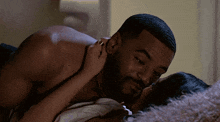 a man and a woman are laying on a bed and kissing