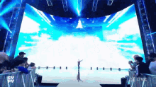 a crowd of people are watching a live show on tv