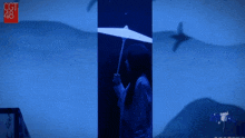 a woman is holding an umbrella in front of a cgt 48 sign