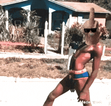 a man in a bikini giving the middle finger