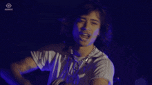 a woman singing into a microphone with the word insomniac in the corner