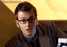 a close up of a man wearing glasses with the hashtag @itsscottiesstark on the bottom