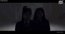 a group of women are dancing in a dark room with a honeycam.org logo in the background