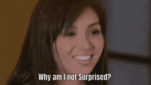 a woman is smiling and saying `` why am i not surprised '' .