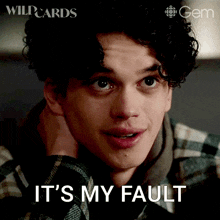 a young man with curly hair has the words it 's my fault written on his face