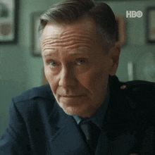 a man in a suit and tie is looking at the camera with a hbo logo in the corner