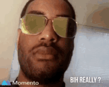 a man wearing sunglasses says " buh really " on the bottom