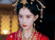 a woman wearing a red dress and a gold necklace