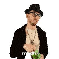 a man wearing a hat and glasses is holding a bag of mcdh candy