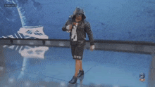 a man in a hooded jacket and shorts that say victory