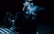 a man in a suit smoking a blue cigarette