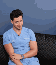 a man wearing a scrub top that says dr. michael thomas on it