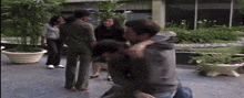 a man is carrying another man in his arms while a woman stands behind them
