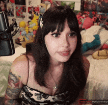 a woman is sitting in front of a microphone with the words what 's your favorite girl on the bottom