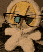 a stuffed animal wearing glasses and a white hoodie