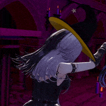 a girl in a witch hat is smoking a cigarette in a dark room
