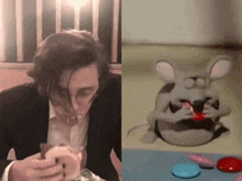 a man in a suit eating a hamburger next to a cartoon mouse