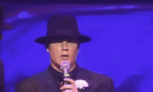 a group of men wearing hats are singing into microphones