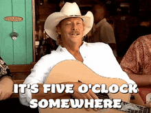 a man in a cowboy hat holding a guitar with the words it 's five o 'clock somewhere above him