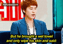 a man in a blue jacket is talking about a wet towel