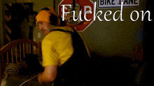 a man wearing headphones is laying on a bed in front of a sign that says " bike lane "