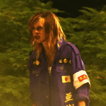 a woman wearing a purple jacket with japanese writing on the sleeves