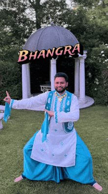 a man in a white shirt and blue pants stands in front of a sign that says bhangra
