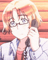 a young man with glasses is talking on a phone