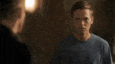 a man wearing a black jacket is looking at another man