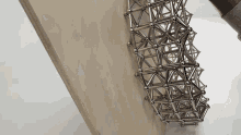 a wooden board with a geometric structure made out of magnets