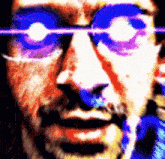 a close up of a man 's face with glowing eyes and glasses .