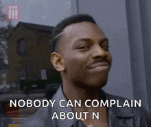 a man is smiling and saying nobody can complain about n .