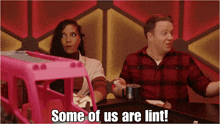 a man and a woman are sitting at a table with the words some of us are lint written below them