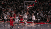 a basketball game is being played in front of a crowd with a toyota ad in the background