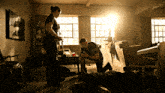 two police officers are kneeling over a man laying on the floor in a dark room