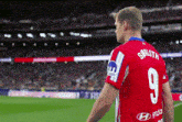 soccer player wearing a red jersey with the number 9 on the back