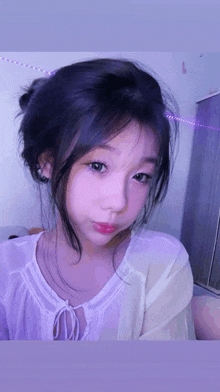 a close up of a girl 's face with purple lights in the background