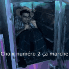 a man in a cowboy hat is sitting in a box with the words hoix numéro 2 ca marche written above him