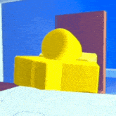 a yellow cartoon character is sitting on a table in a room .