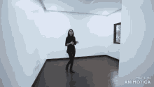 a woman standing in an empty room with the words made in animatica on the bottom