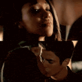a man and a woman are kissing in a dark room