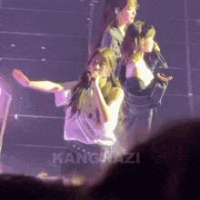 a girl singing into a microphone with kanguazi written on the bottom