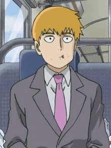 a man in a suit and tie is sitting in a bus