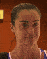 a close up of a woman 's face with a yellow sign in the background that says exit