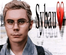 a young man wearing glasses stands in front of a sign that says sylvain