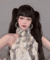 a woman wearing a fur coat and hoop earrings