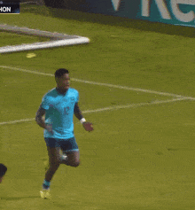 a soccer player in a blue jersey with the number 12 on it