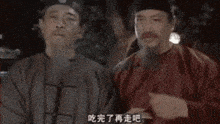 a man is eating a piece of food with chopsticks in a crowd of people .