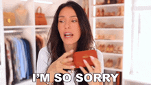 a woman is holding a wallet and saying " i 'm so sorry "