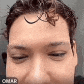 a close up of a person 's face with a spider on it .